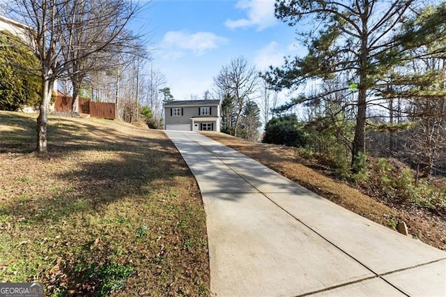 view of front of house with driveway and fence