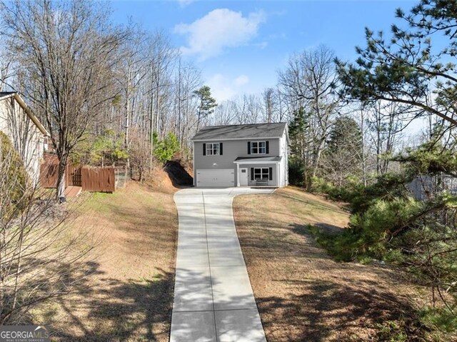 view of front property with covered porch and a garage