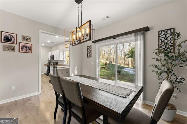 living room with ceiling fan, light hardwood / wood-style flooring, and a wealth of natural light