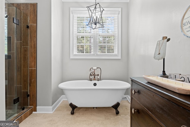 bathroom featuring an inviting chandelier, separate shower and tub, and vanity