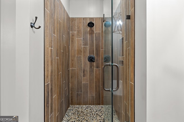 bathroom with a shower with shower door