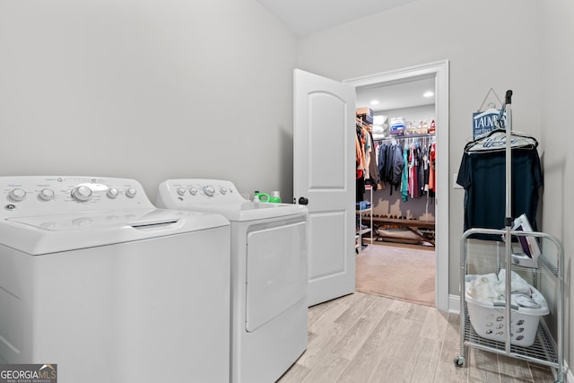 laundry area featuring light hardwood / wood-style floors and independent washer and dryer