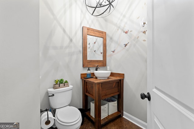 bathroom featuring toilet, hardwood / wood-style flooring, and sink