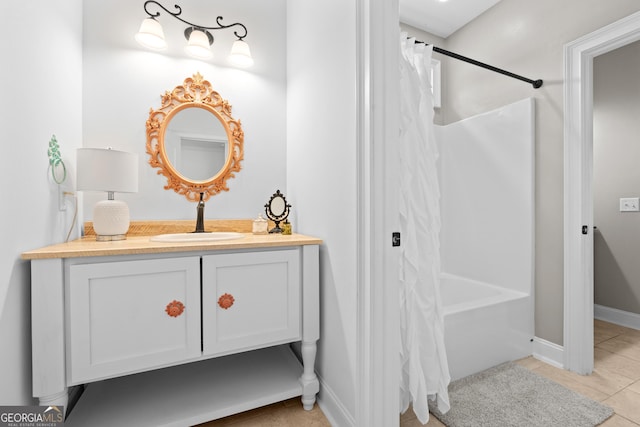 bathroom with tile patterned floors, shower / tub combo with curtain, and vanity