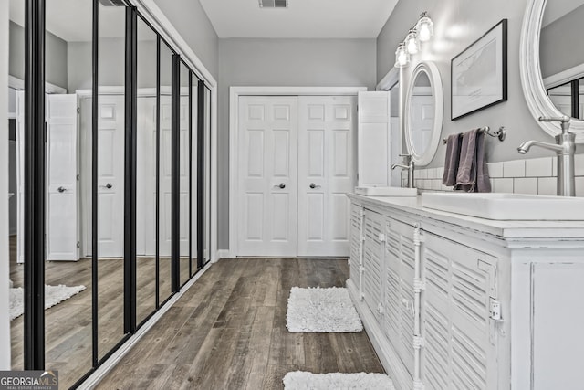 bathroom featuring vanity and wood-type flooring