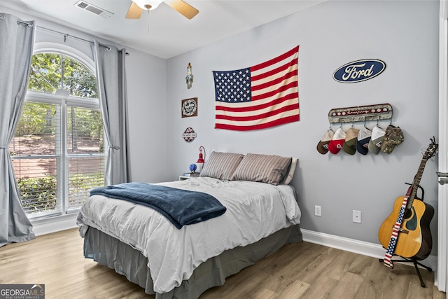 bedroom with ceiling fan and light wood-type flooring