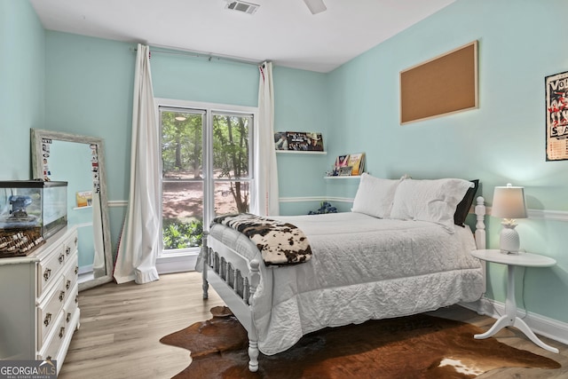 bedroom with ceiling fan and light hardwood / wood-style flooring