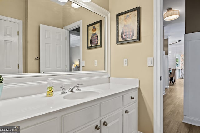 bathroom with hardwood / wood-style floors and vanity