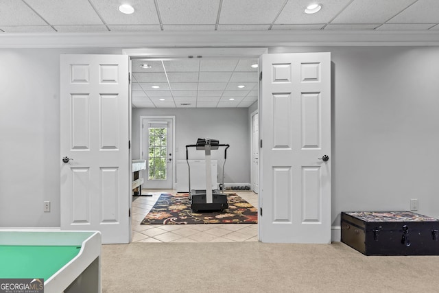 workout room featuring carpet floors and a drop ceiling