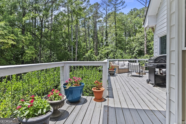 wooden terrace featuring area for grilling