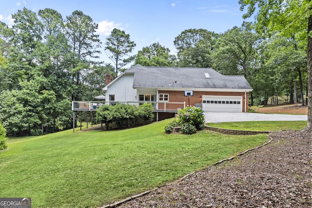 view of front of home with a deck, a front yard, and a garage