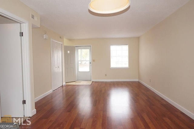 spare room featuring dark hardwood / wood-style flooring