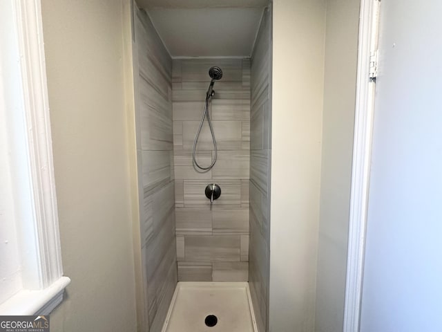 bathroom with tiled shower