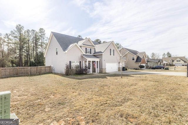 view of front of home featuring a front yard and a garage