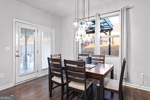 dining space with dark hardwood / wood-style flooring and a wealth of natural light