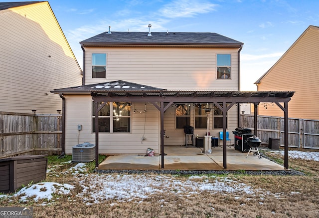 snow covered back of property featuring a pergola, cooling unit, and a patio