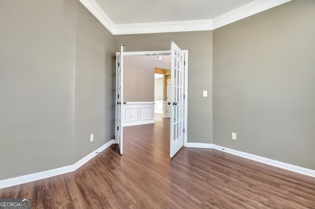 unfurnished room with french doors, baseboards, dark wood-type flooring, and crown molding