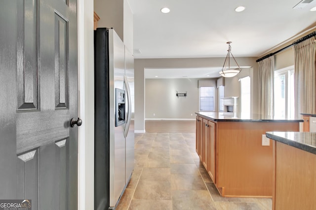 kitchen featuring dark countertops, recessed lighting, stainless steel fridge with ice dispenser, and visible vents