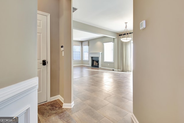 corridor featuring visible vents and baseboards