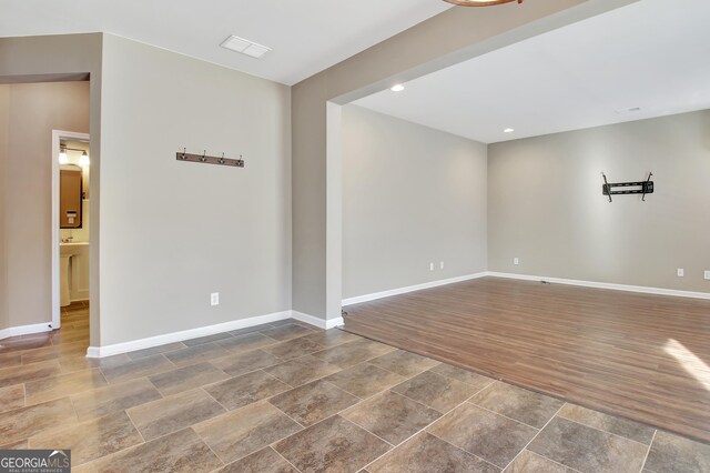 unfurnished room with recessed lighting, baseboards, and dark wood-style flooring