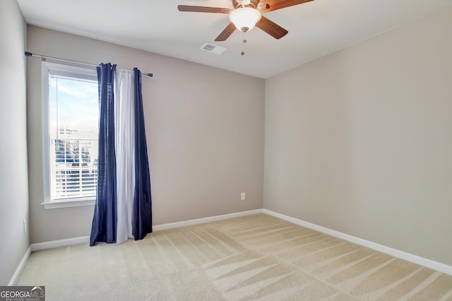 spare room featuring visible vents, baseboards, carpet, and a ceiling fan