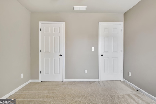 unfurnished bedroom featuring visible vents, baseboards, and carpet floors