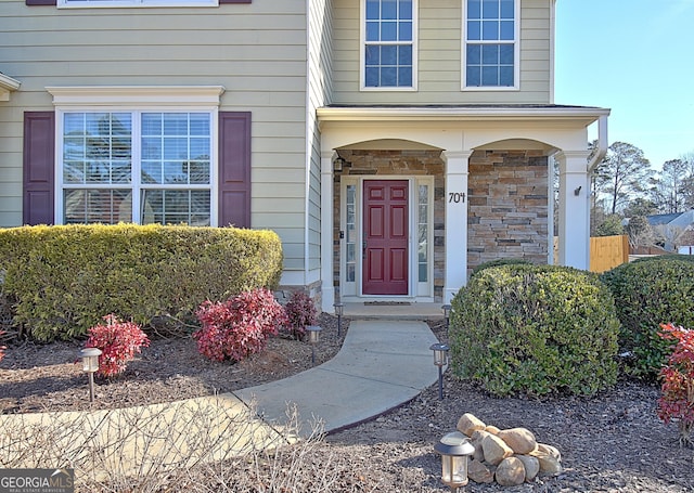 property entrance with stone siding