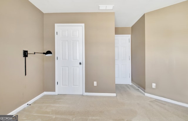 unfurnished bedroom featuring visible vents, carpet floors, and baseboards