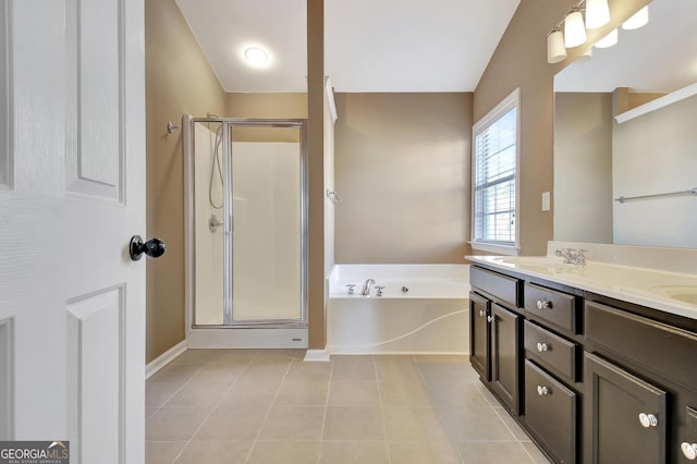 bathroom with a stall shower, a sink, tile patterned flooring, double vanity, and a bath