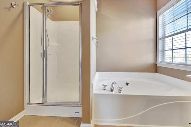 full bath with tile patterned flooring, a garden tub, and a stall shower