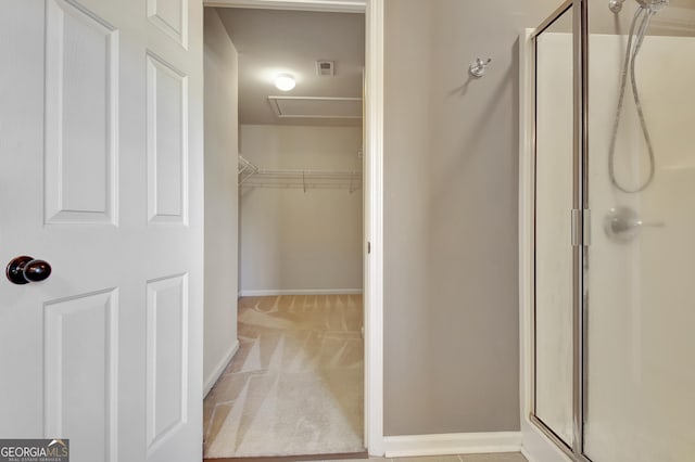 full bathroom featuring a shower stall, visible vents, and baseboards