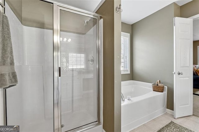 bathroom featuring plus walk in shower and tile patterned floors