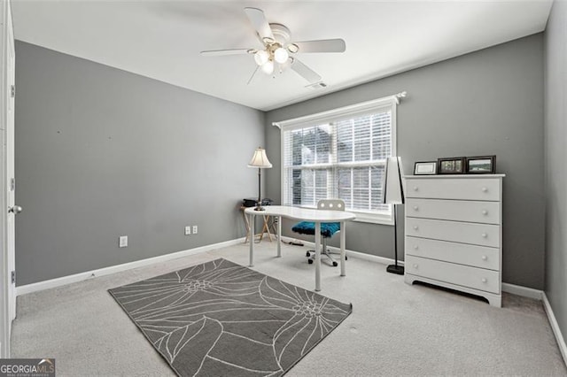 office space with ceiling fan and light carpet