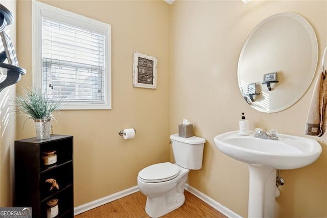 bathroom featuring sink, toilet, and hardwood / wood-style flooring