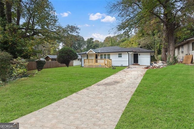 ranch-style house featuring a front yard and a deck