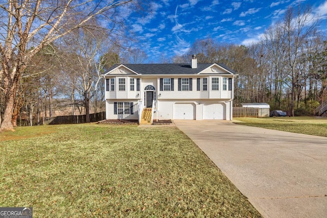 bi-level home with a front yard and a garage