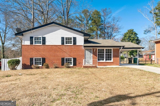 tri-level home with a front lawn and a carport