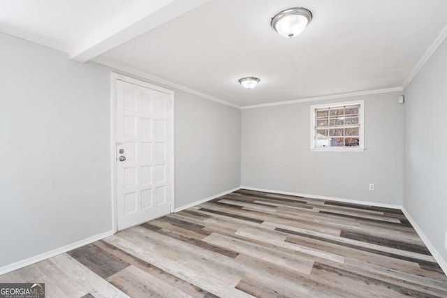 spare room with hardwood / wood-style flooring and ornamental molding