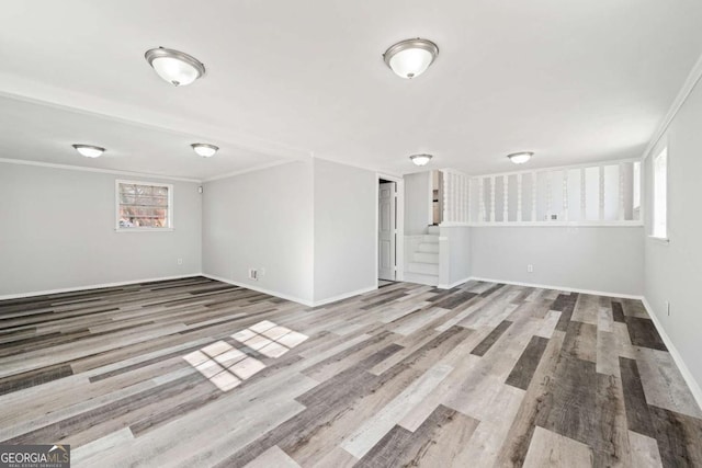 empty room with ornamental molding and hardwood / wood-style floors