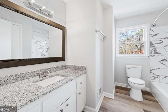 full bathroom featuring toilet, shower / bathing tub combination, wood-type flooring, and vanity