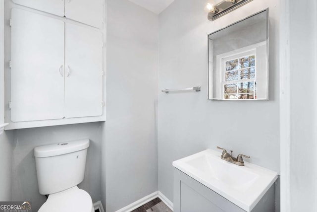 bathroom featuring toilet and vanity