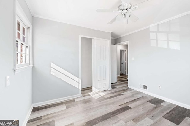 spare room featuring ceiling fan, crown molding, and light hardwood / wood-style flooring