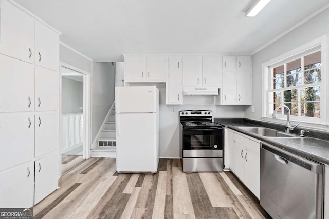 kitchen featuring sink, stainless steel appliances, light hardwood / wood-style flooring, and white cabinets