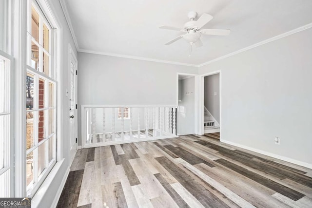 spare room featuring ceiling fan, ornamental molding, and wood-type flooring