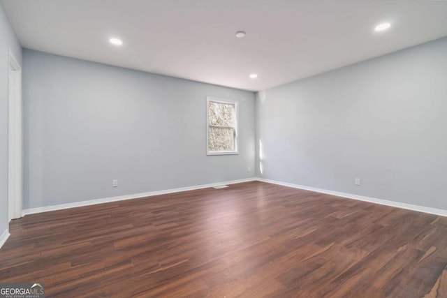 unfurnished room featuring dark wood-type flooring