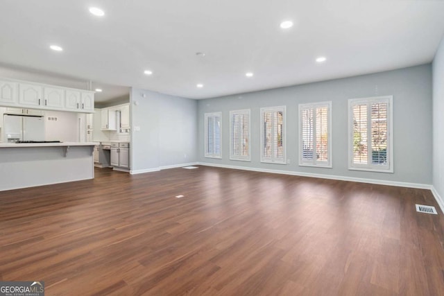 unfurnished living room featuring dark hardwood / wood-style flooring