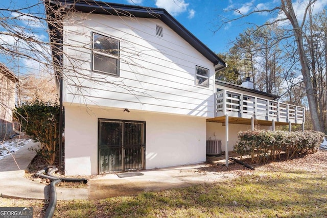 back of house featuring central AC unit