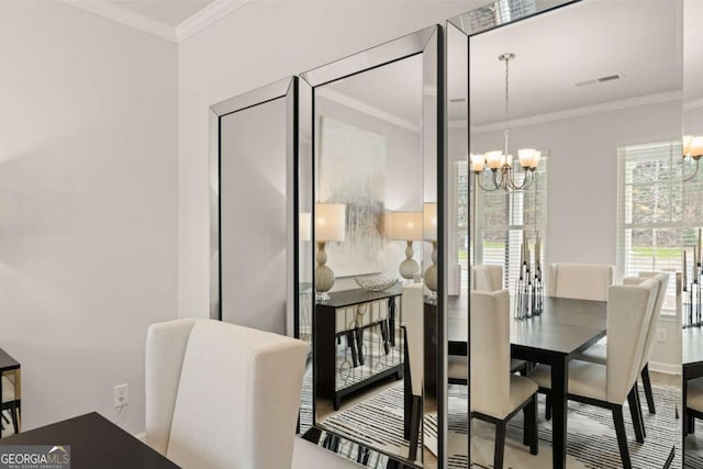 dining area featuring a notable chandelier and crown molding