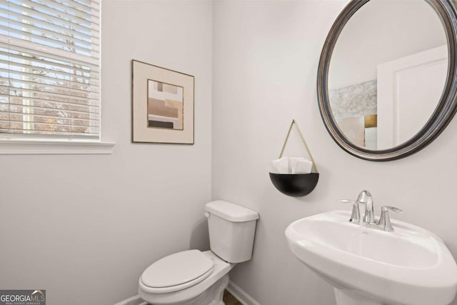 bathroom featuring sink, plenty of natural light, and toilet