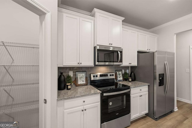 kitchen featuring stainless steel appliances, white cabinetry, light stone countertops, and light hardwood / wood-style flooring